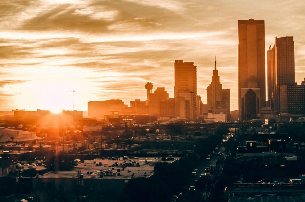 Stunning Dallas skyline at sunset, showcasing vibrant colors and iconic architecture.