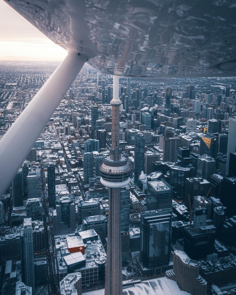 Stunning aerial capture of the CN Tower amidst Toronto's cityscape on a wintry day.
