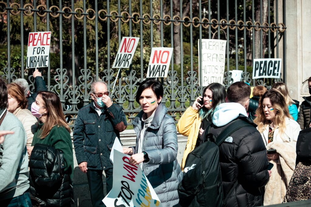 A peaceful protest in Madrid advocating for Ukraine, featuring diverse participants with signs.