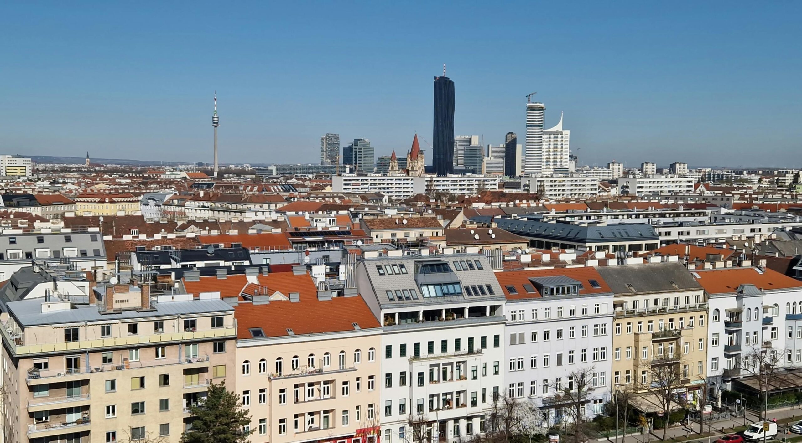 Aerial view of Vienna capturing the city's skyline under a clear blue sky.