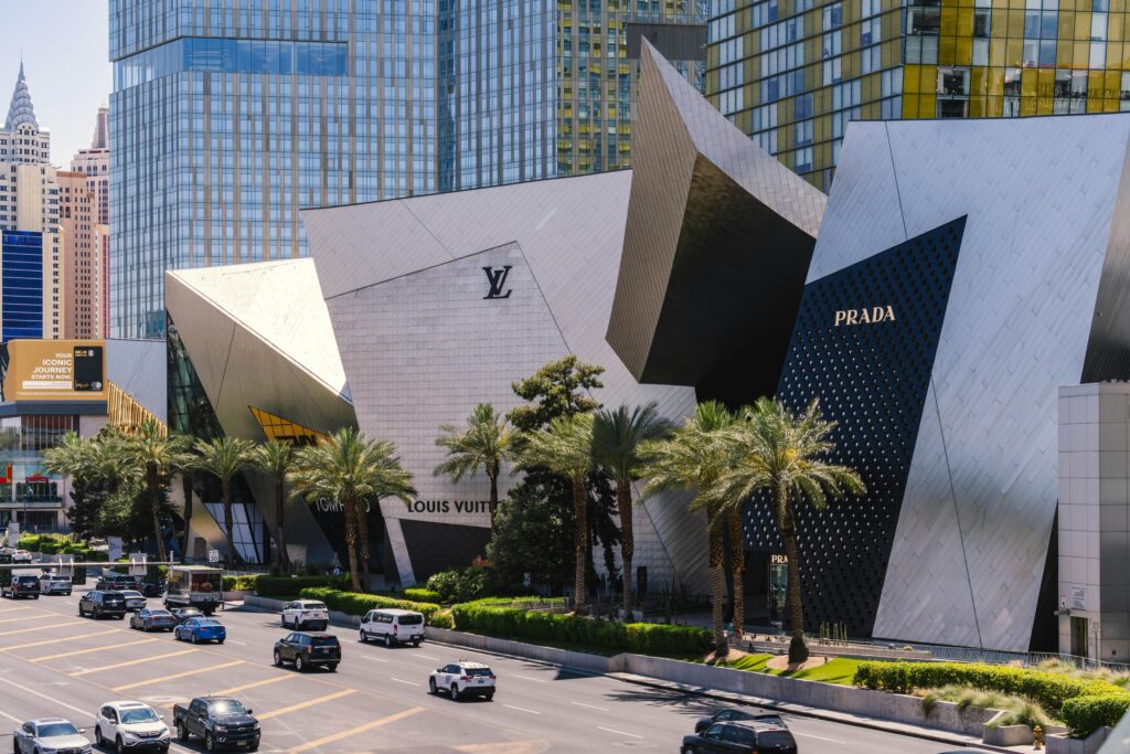 A modern Prada storefront on the Las Vegas Strip with iconic city architecture in view.