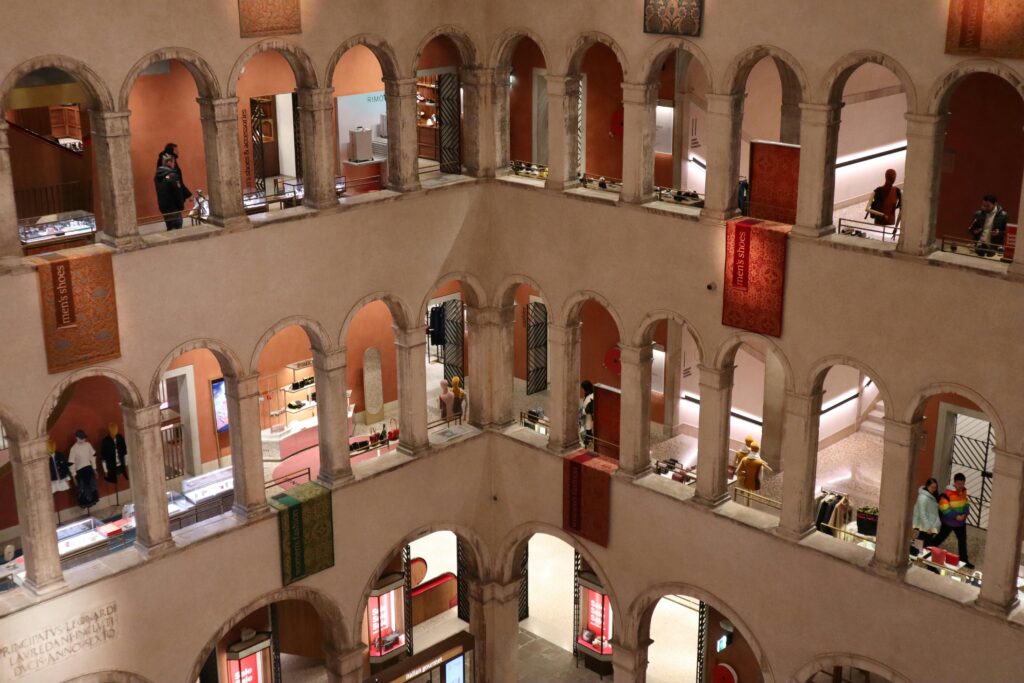 Elegant Venetian mall interior with arches, blending historic architecture and modern retail ambiance.