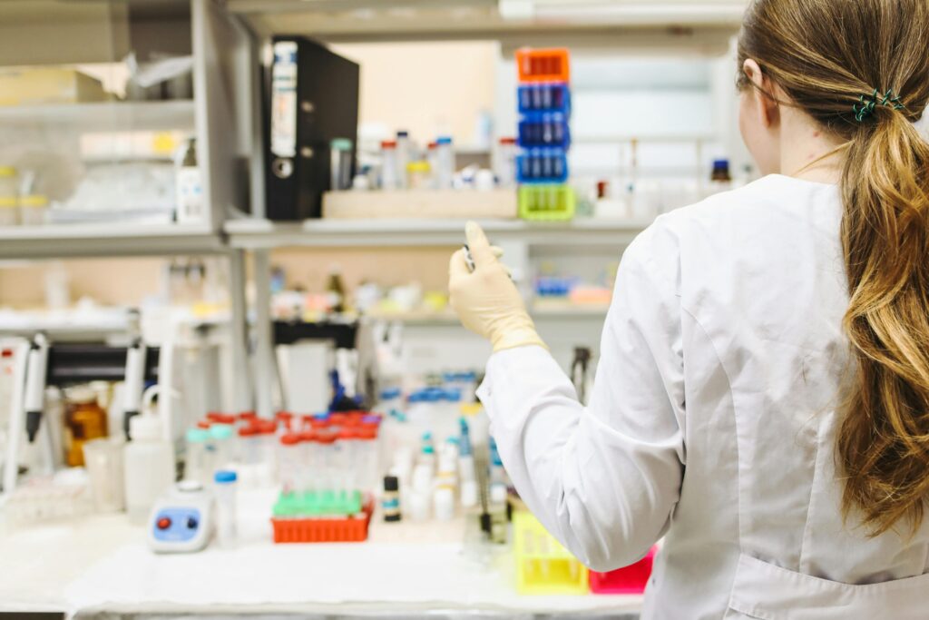 A woman in a laboratory setting conducting scientific research with test tubes.