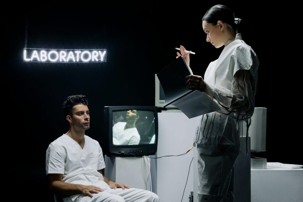 Two scientists in a futuristic laboratory setting analyzing data and conducting research on a subject.