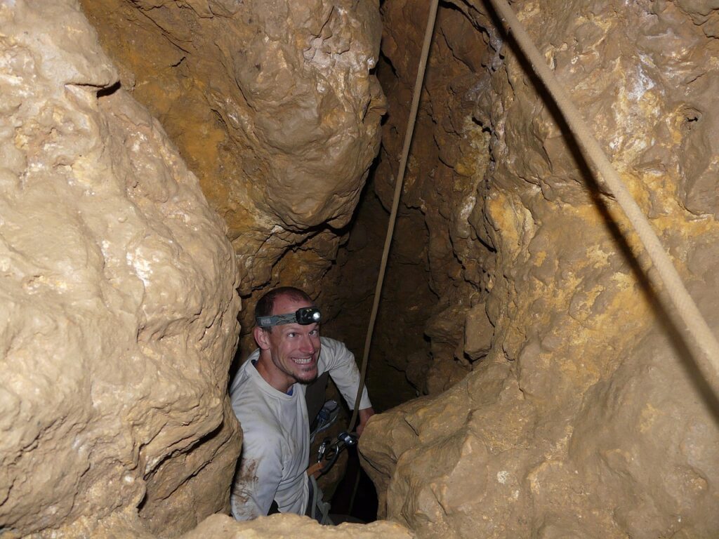 cave, cave tour, neanderthals, primitive man, caveman, stone age man, adventure, squint, grimace, fun, dangerous, wet, slippery, abseil, closely, cavity, descent, backup, steep, deep, helmet lamp, headlamp, light, clay, climb, caving, cave exploration, research, explore, geology, rock, rock strata, wall, stone, primitive man, primitive man, caveman, caveman, caveman, caveman, caveman