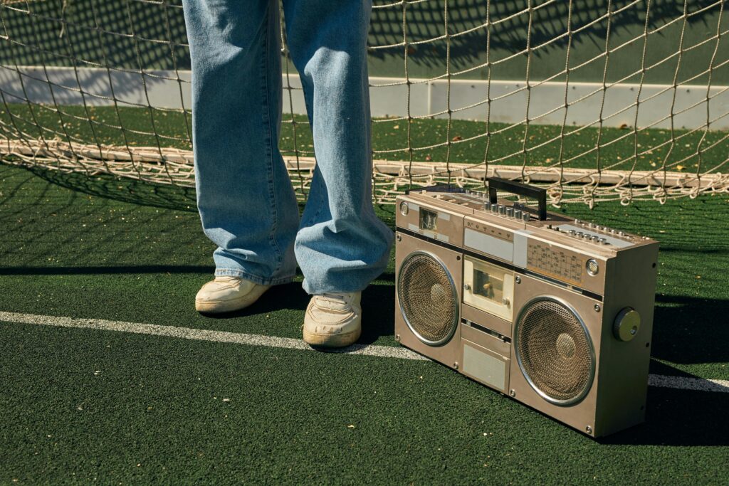 Classic boombox on a sportsground with retro style and street fashion vibes.