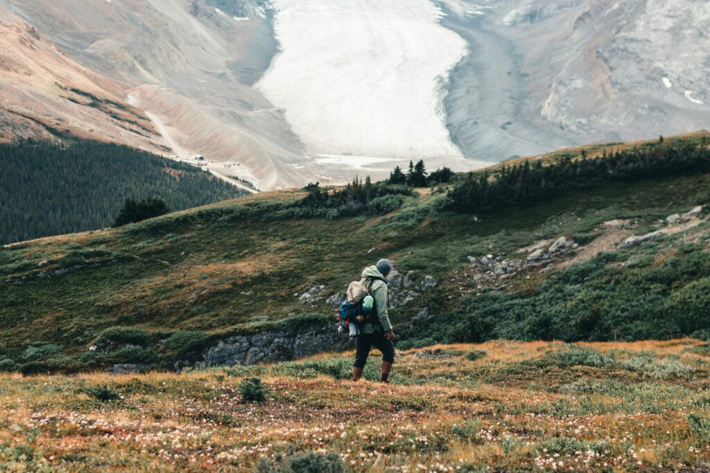 Solo hiker explores scenic trail in Jasper National Park with breathtaking mountain views.