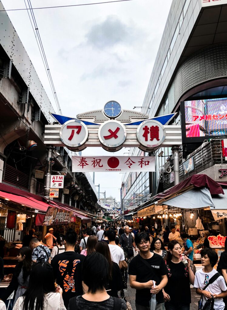 Explore the vibrant Ameyoko Shopping Street with bustling crowds and diverse stalls in Tokyo, Japan.
