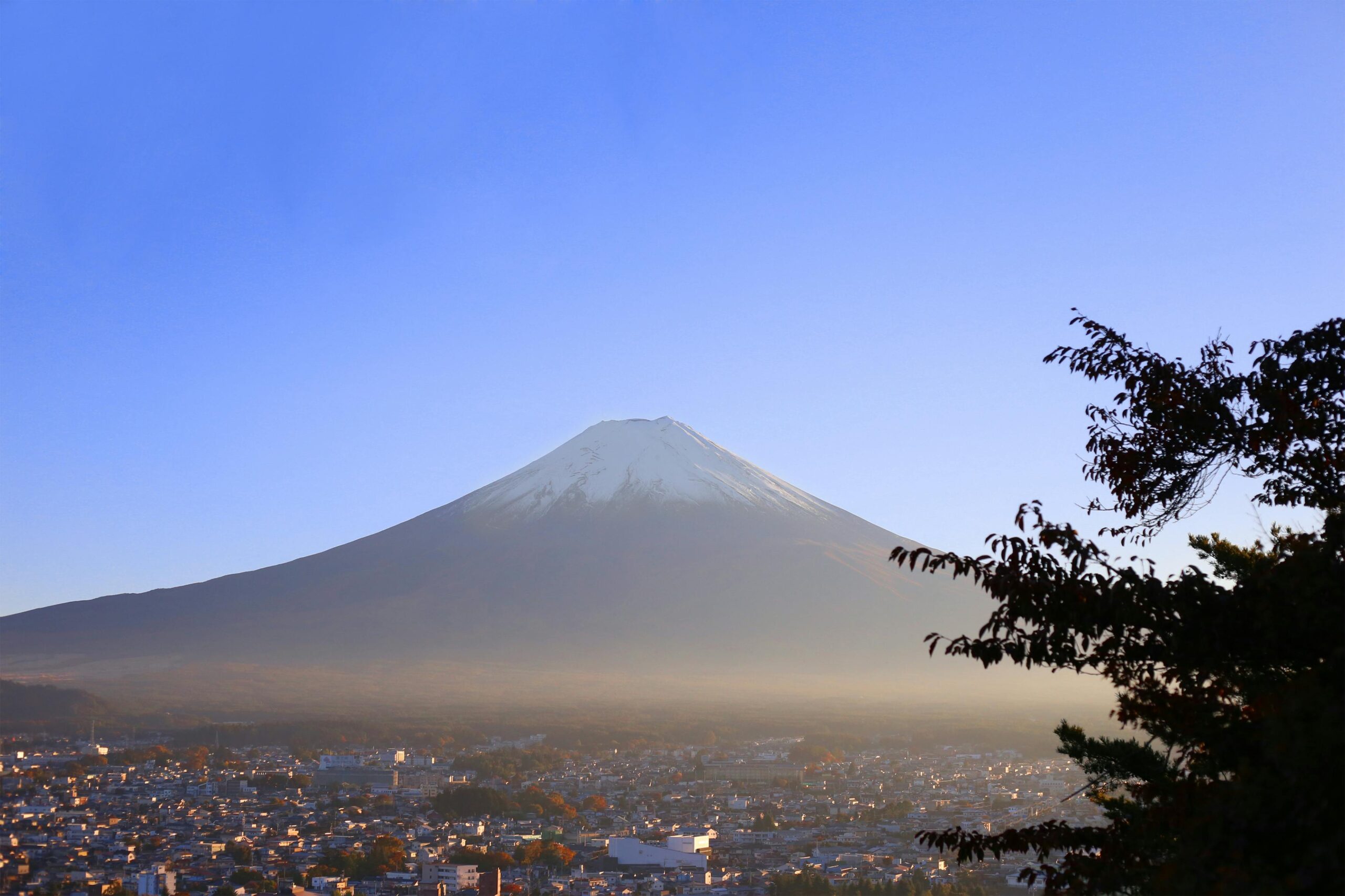 Capture of Mount Fuji at sunrise over Fujiyoshida, showcasing its iconic silhouette.