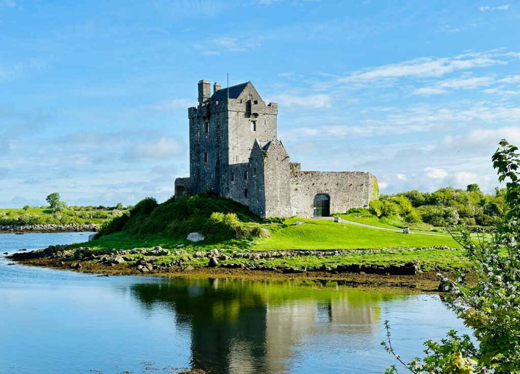 A picturesque portrayal of the historic Dunguaire Castle by the sea in Ireland, perfect for travel inspiration.