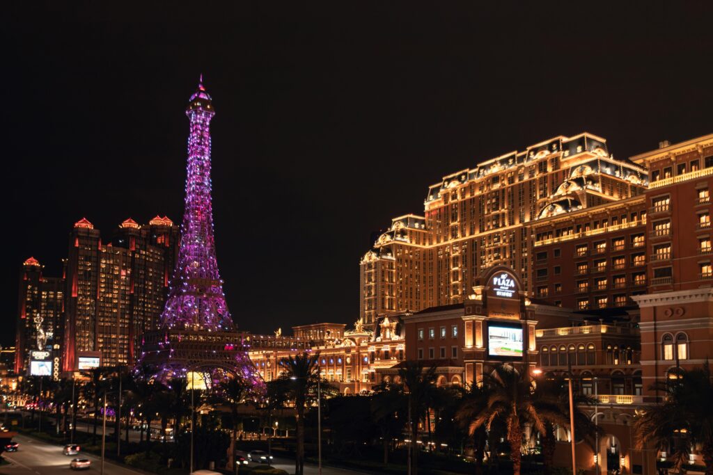 Vibrant night view of the Parisian Macao featuring its iconic illuminated Eiffel Tower replica.