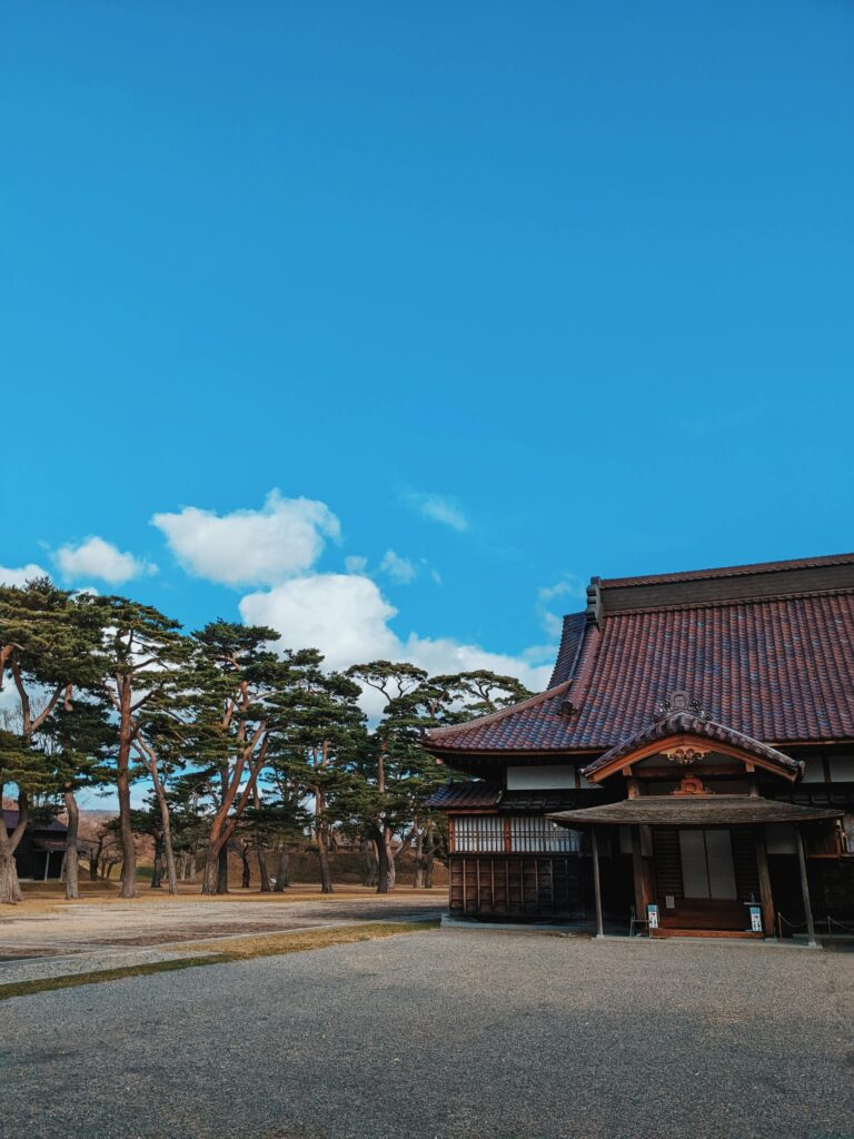 Explore a tranquil traditional temple in Hakodate, Hokkaido under a vibrant blue sky.