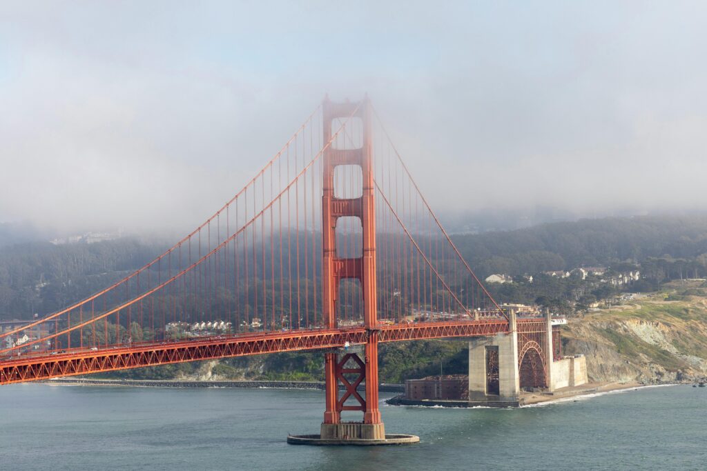 Golden Gate Bridge with dense morning fog and scenic landscape in San Francisco.