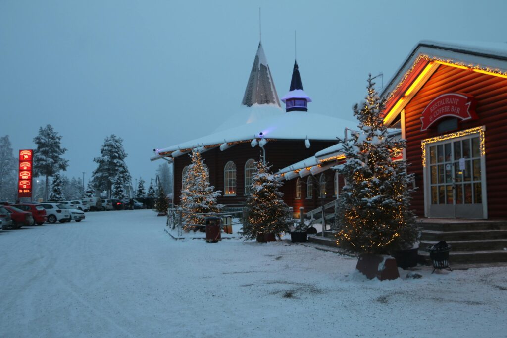 A festive twilight scene of Santa Claus Village in snowy Rovaniemi, Lapland, Finland.