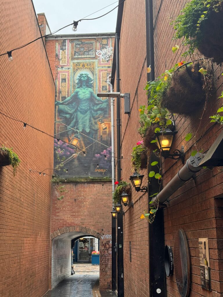 Pottinger's Entry - Mural and hanging plants in an alley in Belfast, Northern Ireland