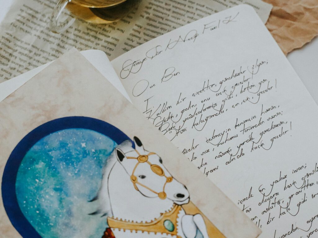 A creative journal setup with handwritten notes, an illustration, and a cup of tea.