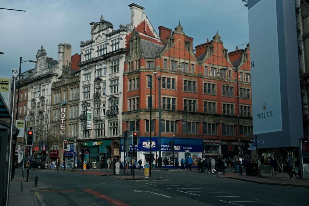 Vibrant city street with historic architecture in Manchester, UK.