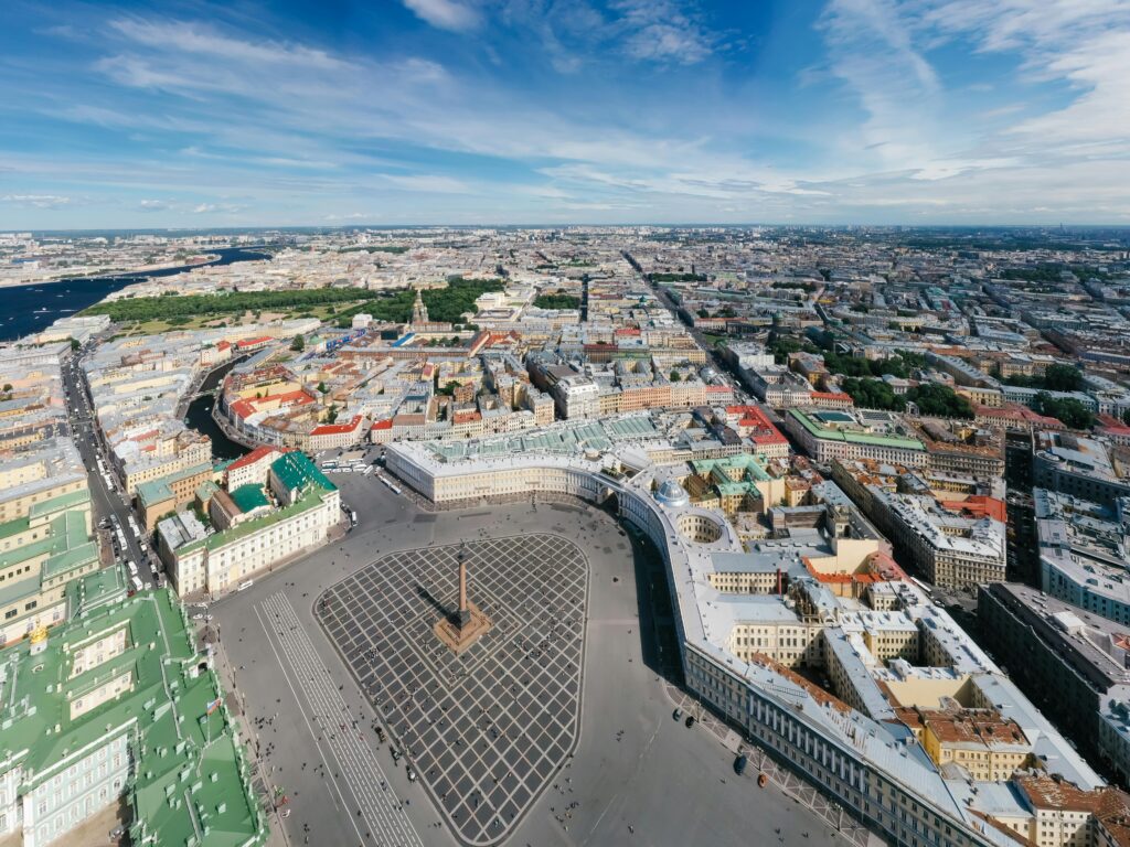 Aerial view of the historic Palace Square in Saint Petersburg, showcasing architecture and city layout.