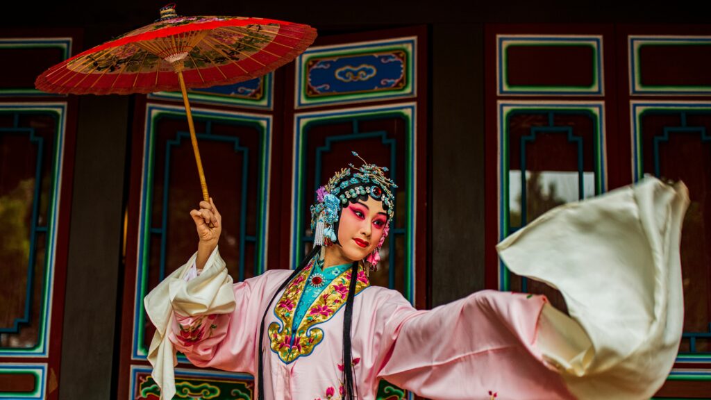 Vibrant portrait of a Chinese opera performer with intricate costume and parasol in Taiwan.