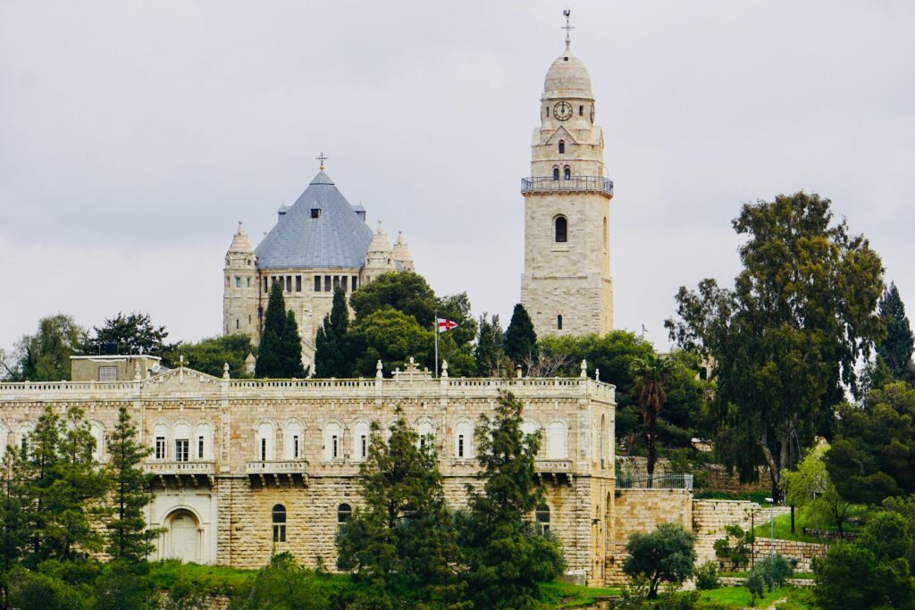 View of Jerusalem's Mount Zion with historic architecture and lush greenery.