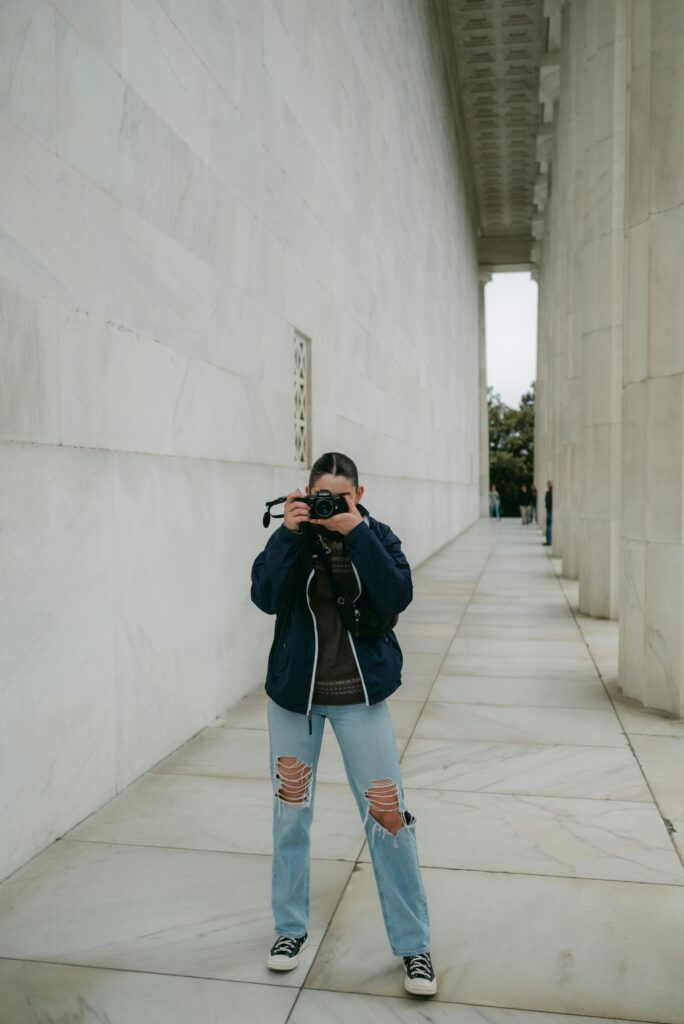 A photographer captures moments in a historic outdoor urban setting, ideal for tourism and travel content.