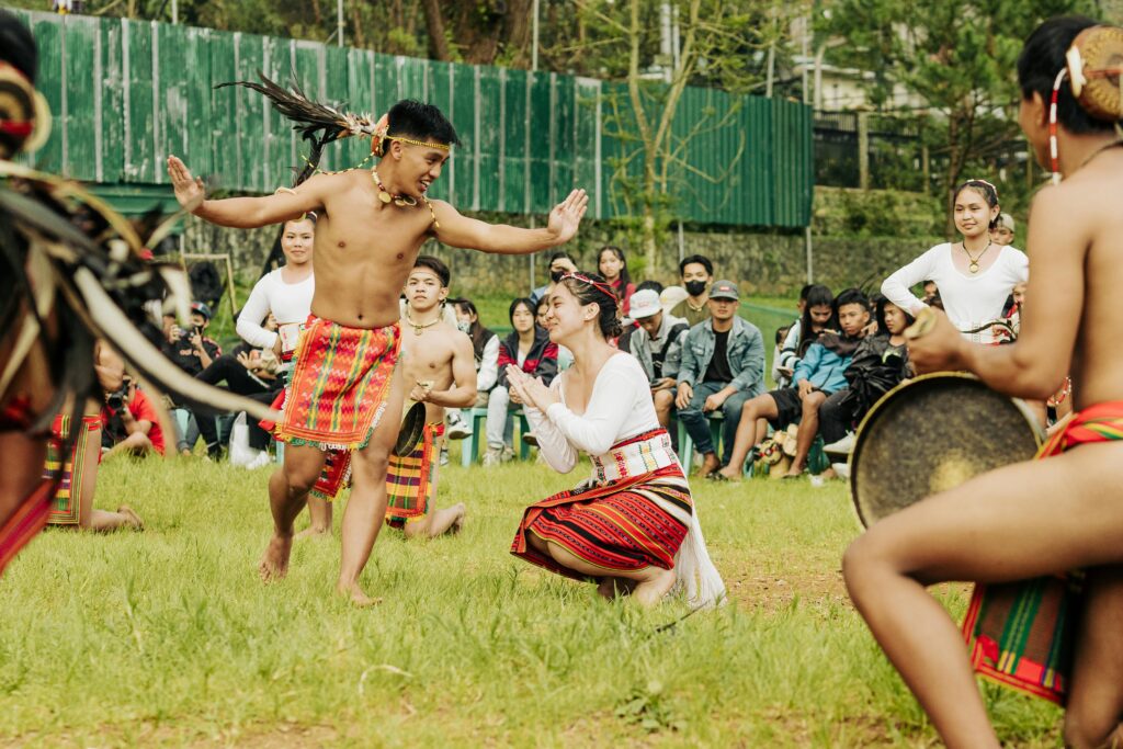 Vibrant display of traditional dance with colorful attire during an outdoor festival.