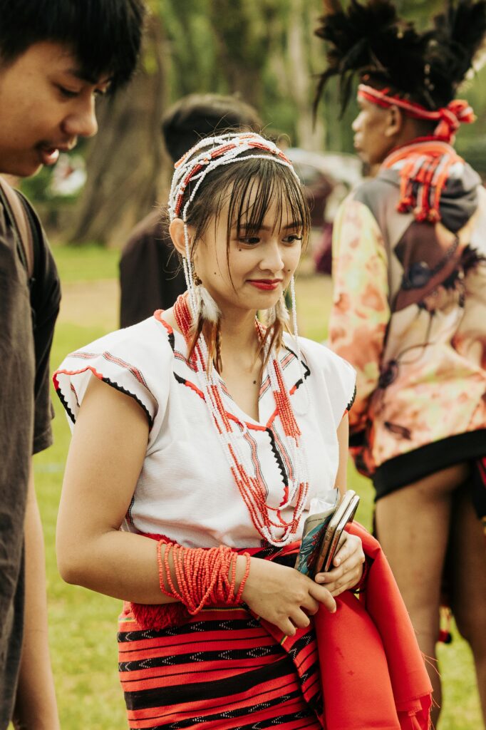Celebrating cultural heritage with traditional attire and festive mood outdoors.
