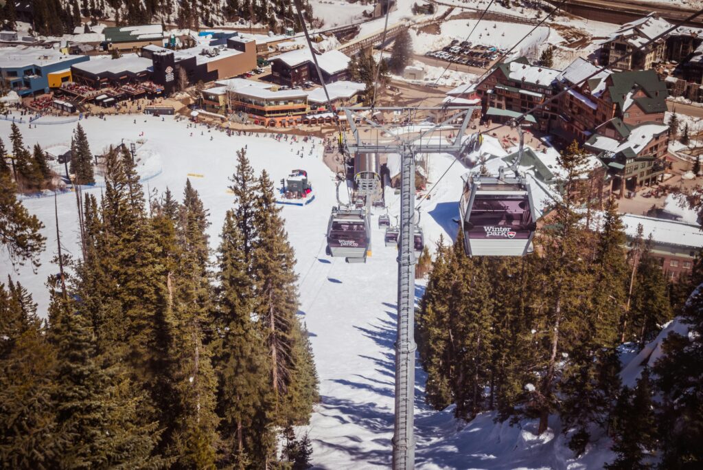 Aerial view of Winter Park ski resort with gondola lift and snow-covered landscape.