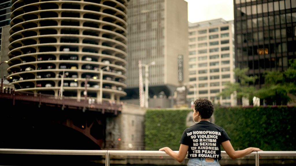 A person standing by a railing, overlooking Marina City Towers, Chicago.