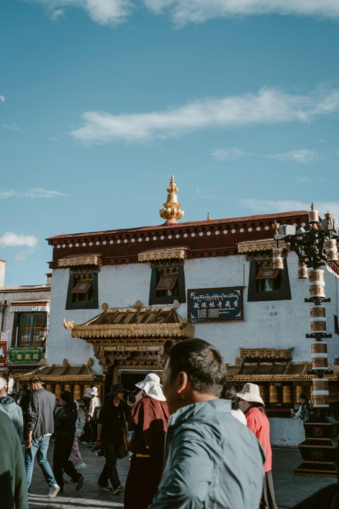 Street scene with Tibetan temple in Almaty, Xinjiang, featuring cultural architecture and local visitors.