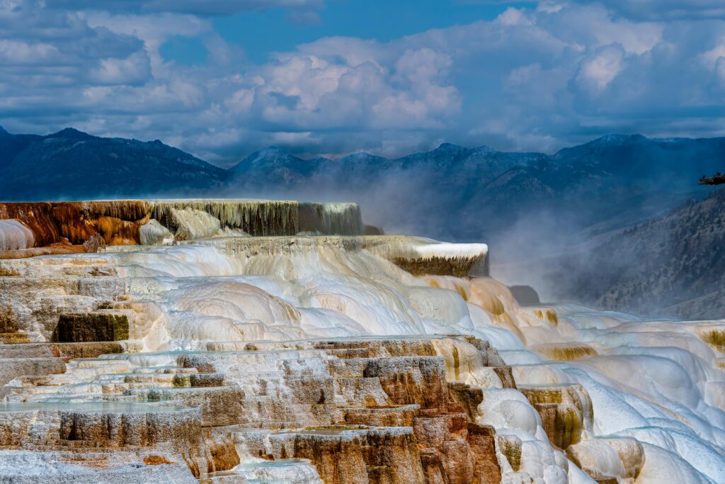 Stunning view of Mammoth Hot Springs terraces in Yellowstone National Park showcasing unique geothermal formations.