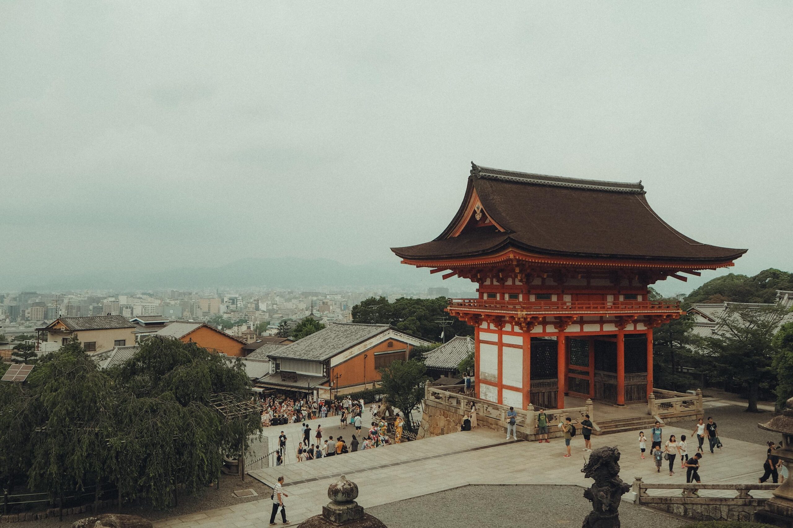 A captivating scene of Kyoto's historic Kiyomizu-dera Temple with a crowd in the foreground.