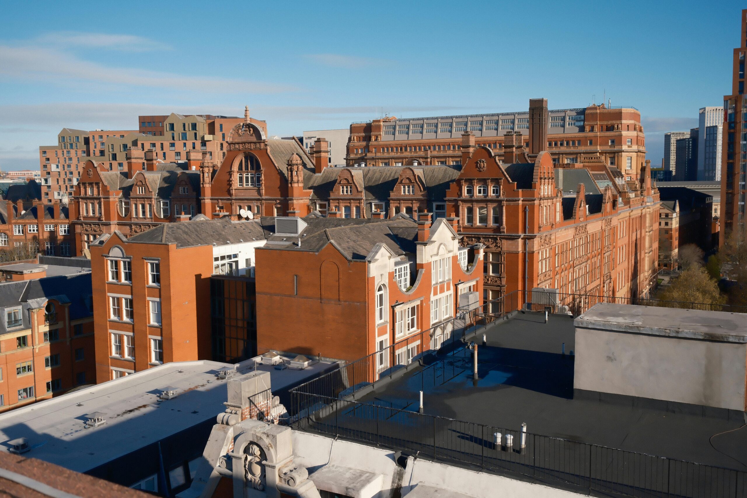 Stunning aerial view of historic red brick buildings in Manchester, showcasing urban architectural design.