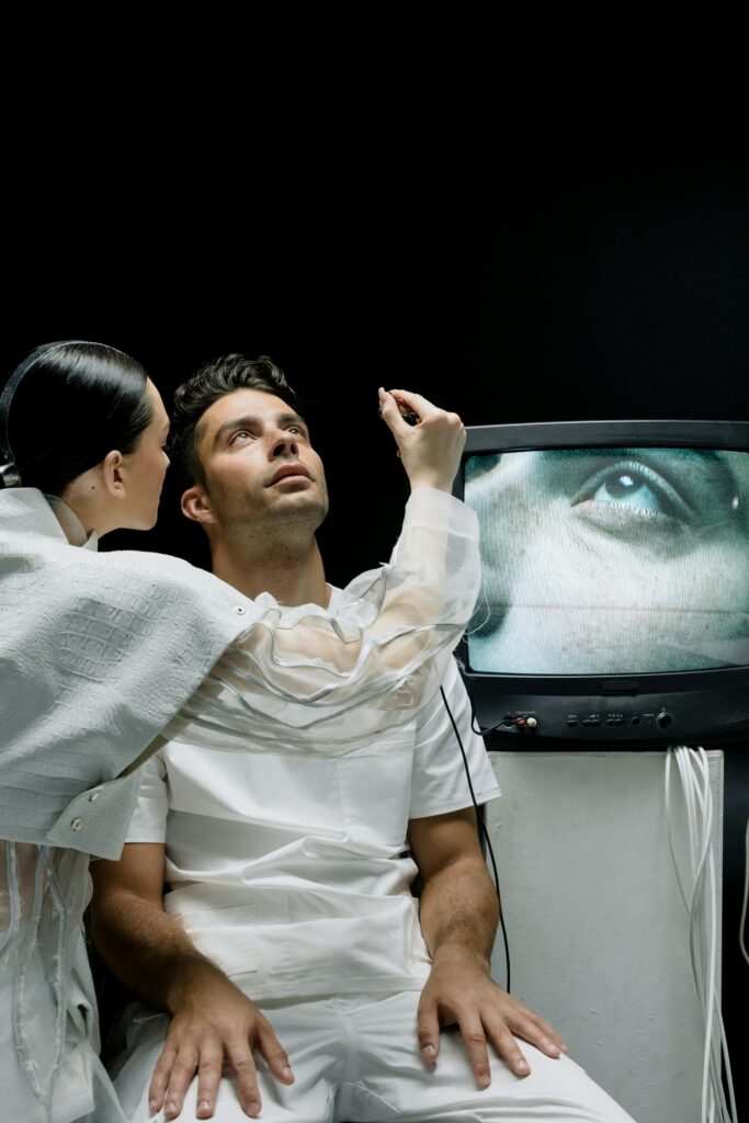 A woman conducts an eye exam using advanced technology on a man in lab coats.