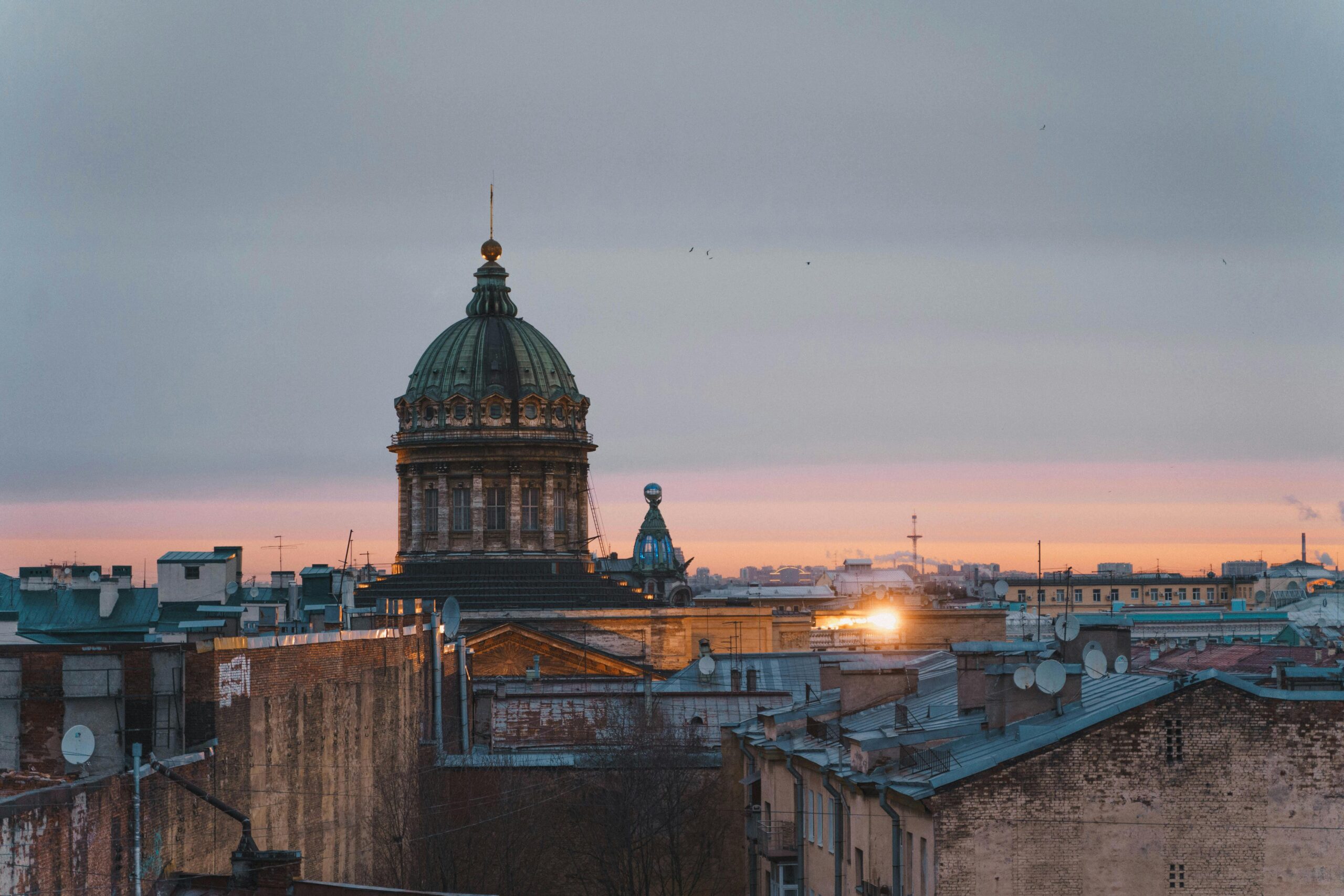 Stunning view of Saint Petersburg's historic rooftops and dome at sunset, capturing the city's charm.