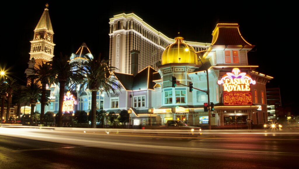 A lively night view of Casino Royale with vibrant lights along the Las Vegas Strip.