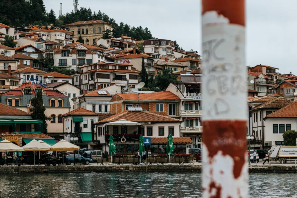 Picturesque waterfront town with red tile roofs and colorful buildings by the sea.