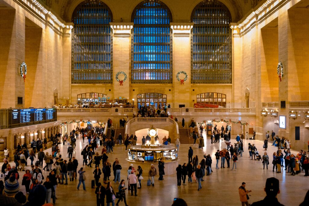 Crowd in Grand Central Terminal, New York, showcasing iconic architecture and lively atmosphere.