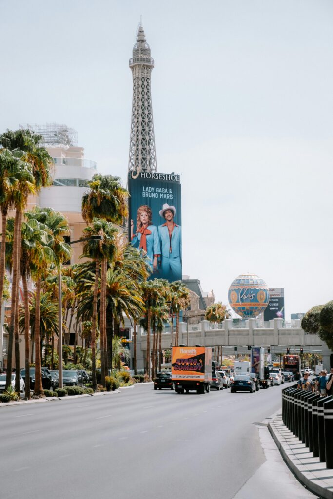 Vibrant view of the Las Vegas Strip featuring the Eiffel Tower replica and bustling city life.