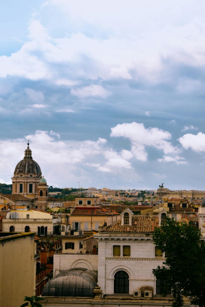 Captivating view of Rome's historic architecture with a serene cloudy sky backdrop.