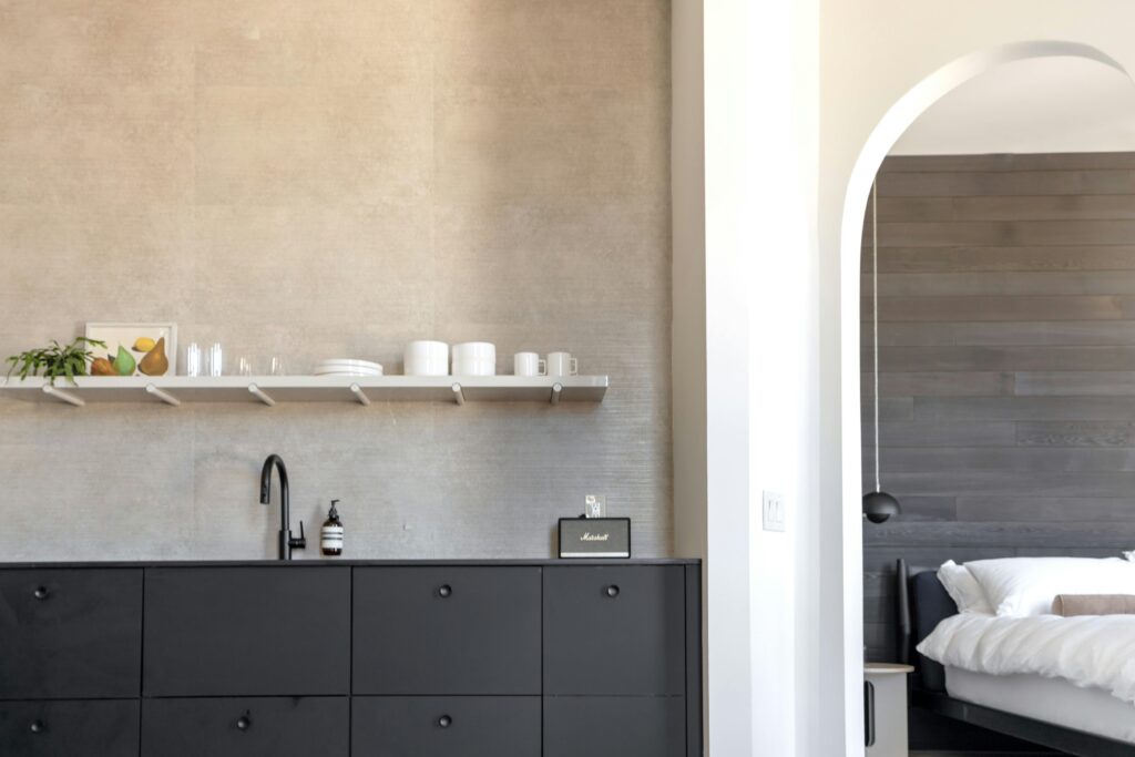Sleek modern kitchen and bedroom archway in a Philadelphia apartment.