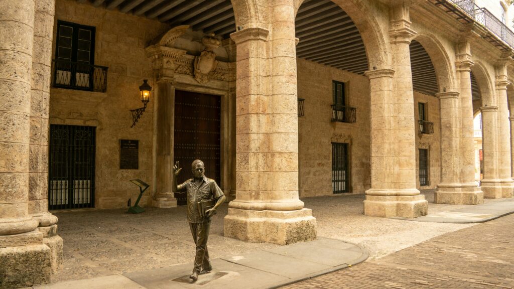 Detailed view of colonial architecture and a bronze statue in the streets of Havana, Cuba.