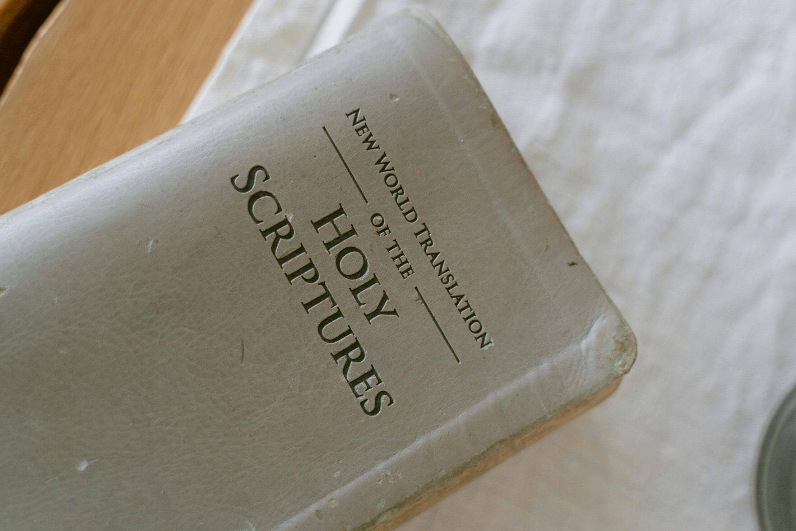 A close-up photo of the New World Translation of the Holy Scriptures on a table.