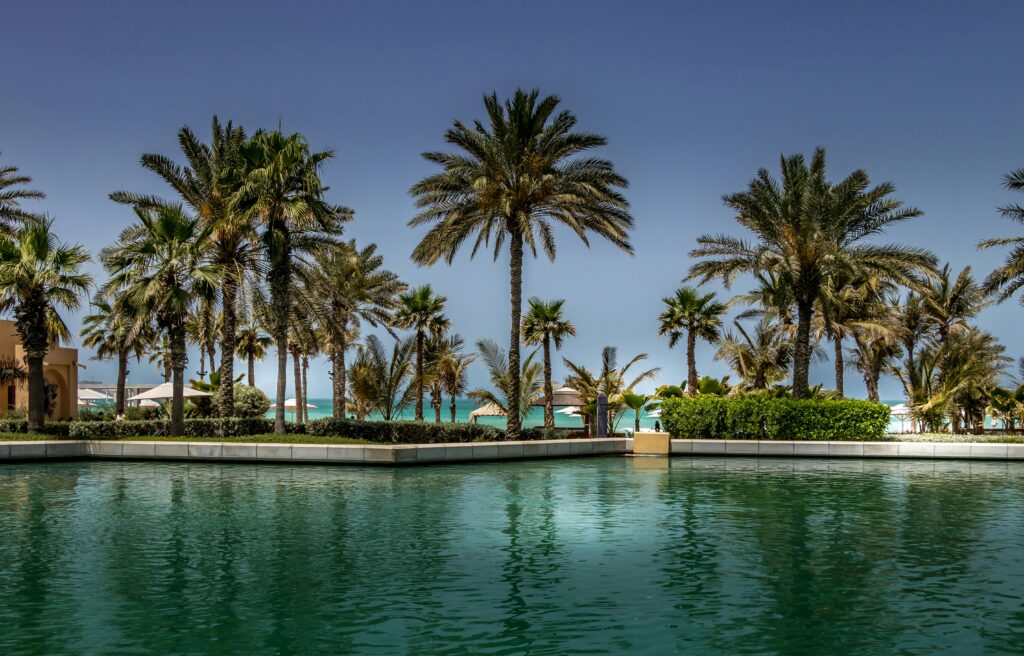 Tranquil resort with palm trees and pool overlooking the beach in Dubai.