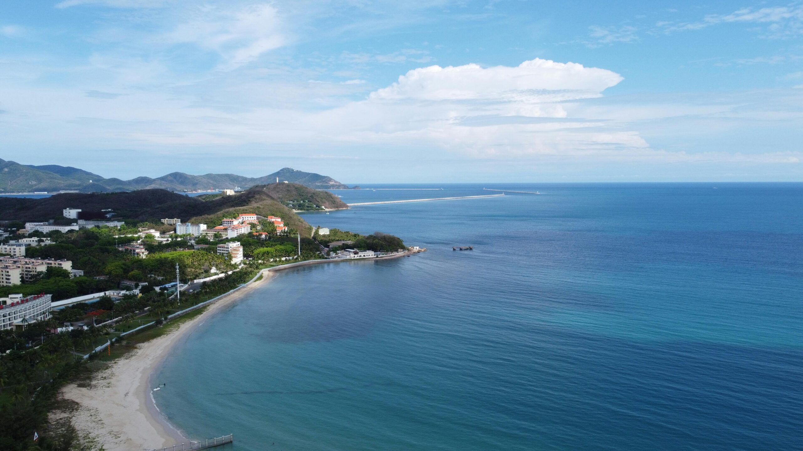 Explore the scenic coastal beauty of Sanya, Hainan with its sandy beaches and lush greenery.