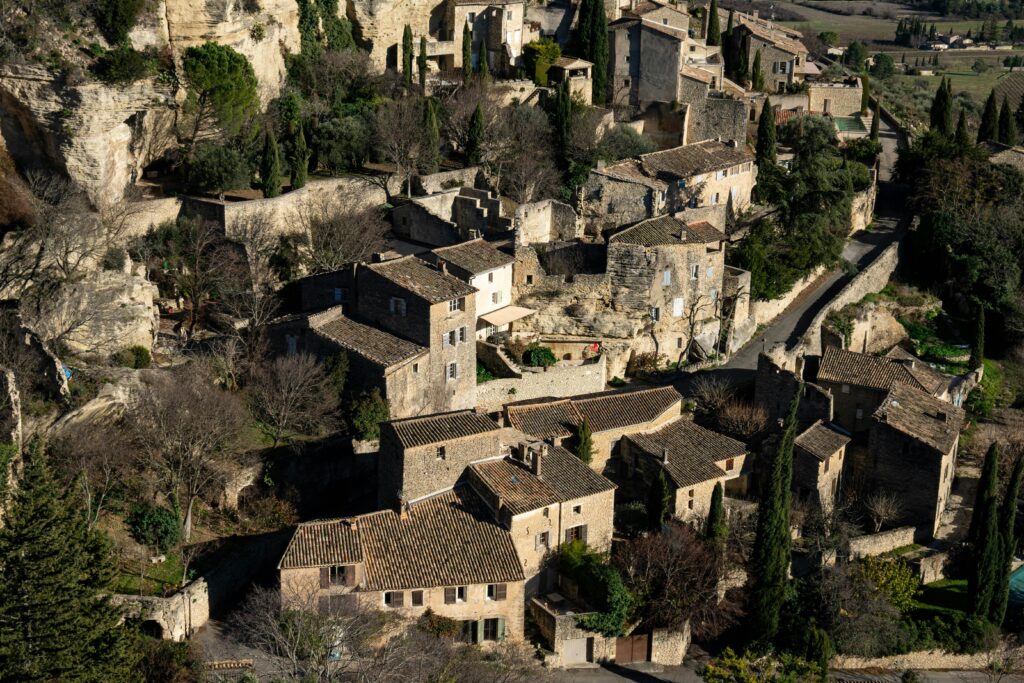 Explore the picturesque village of Gordes, a historic gem in Provence with rustic stone houses and lush greenery.