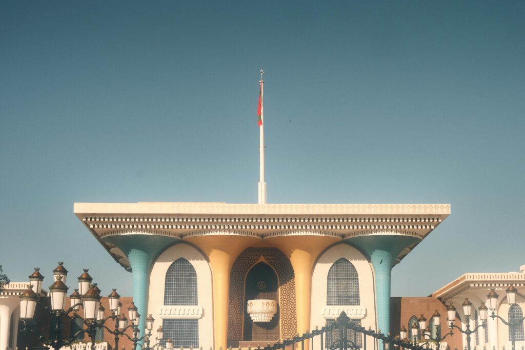 Explore Al Alam Palace, a historic landmark in Muscat, Oman, showcasing its vibrant Islamic architecture.