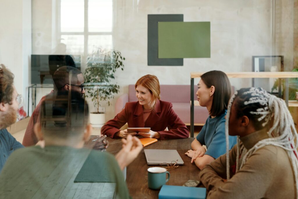 A multicultural team collaborates in a modern office, fostering creativity and teamwork.