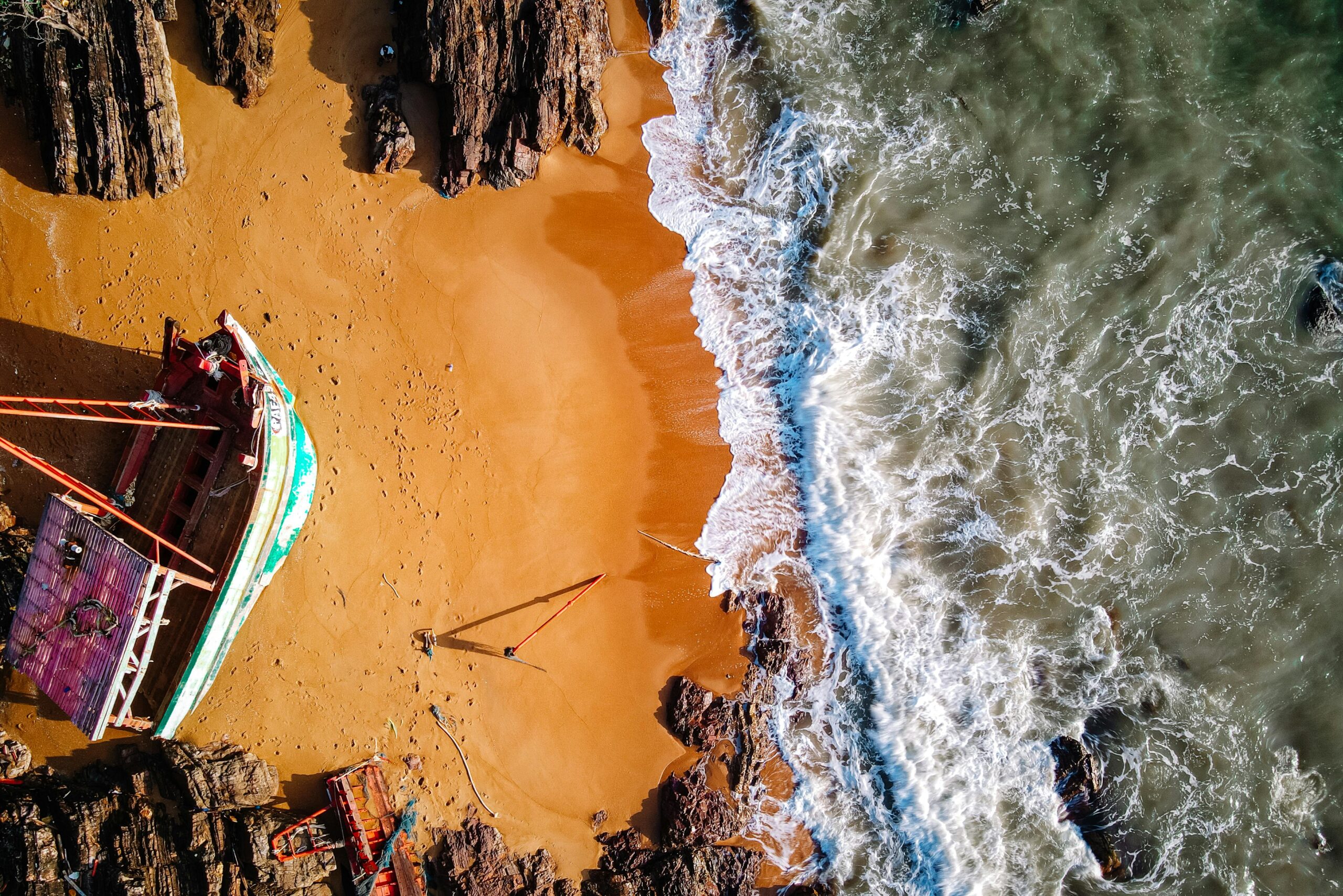 A stunning aerial shot of a wrecked boat on the sandy shores of Chukai, Terengganu, Malaysia.