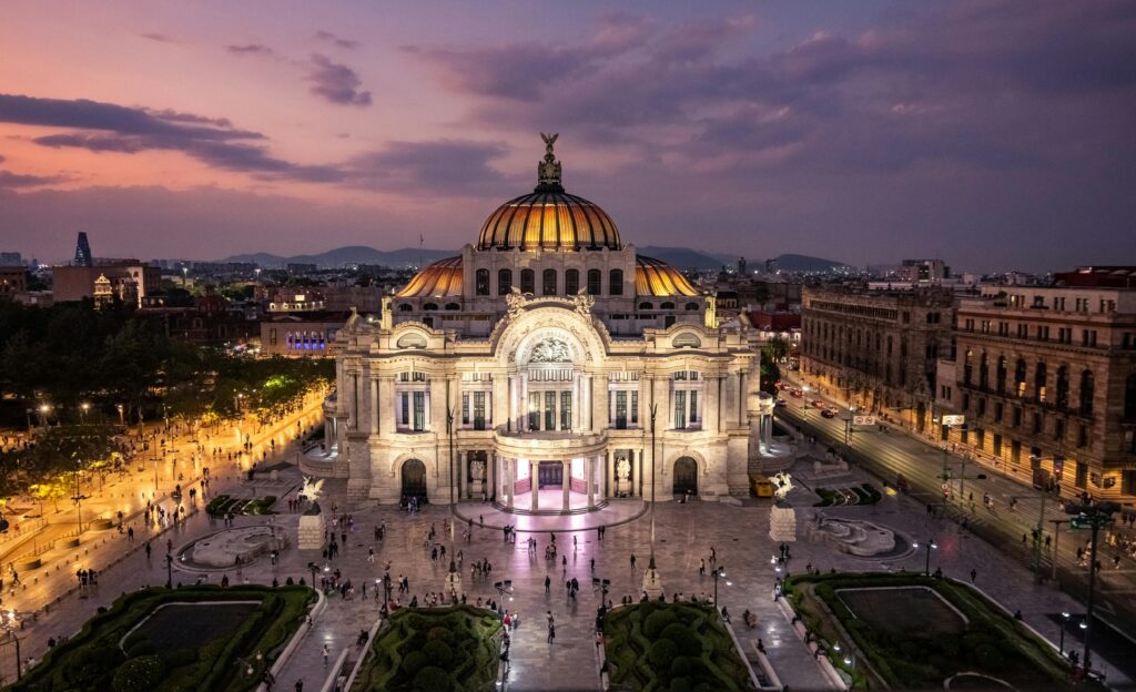 Stunning sunset view of Palacio de Bellas Artes, showcasing its architecture in Mexico City.